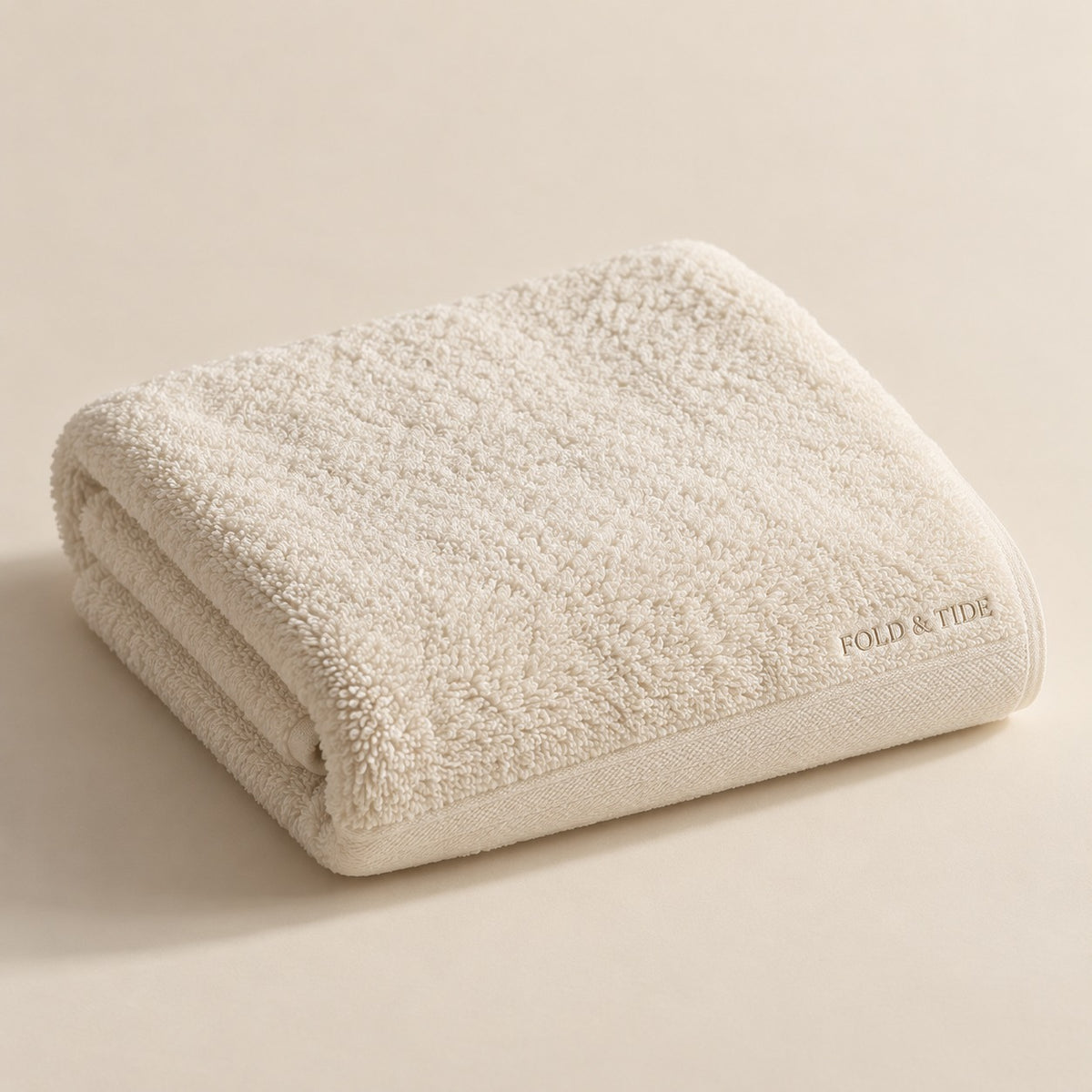 Fold & Tide ivory towel design concept — not an approved physical product photograph