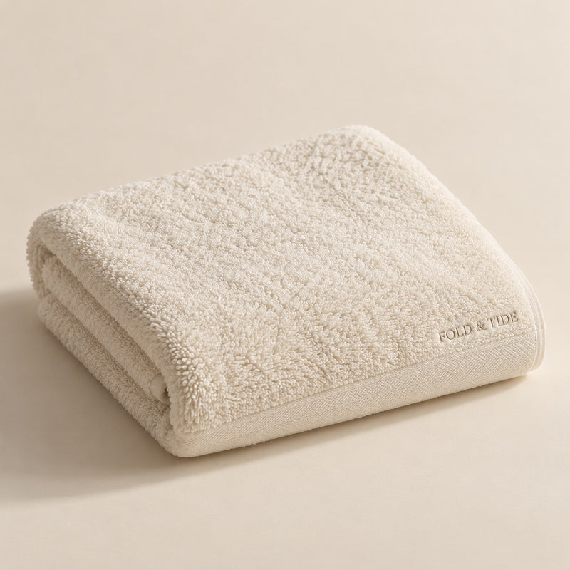 Fold & Tide ivory towel design concept — not an approved physical product photograph